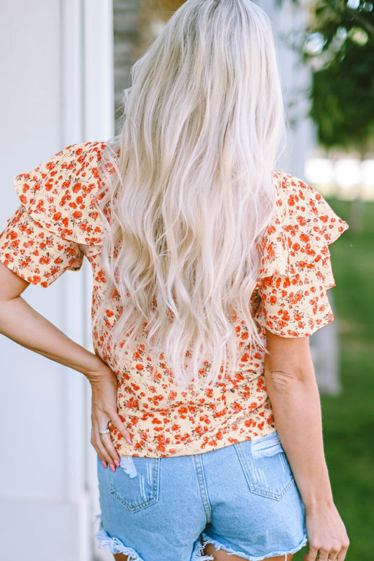 Blouse fleurie orange à manches flottantes et à plusieurs niveaux