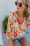 Blouse orange à manches bouffantes et à volants et fleurs épanouies