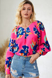 Blouse noire à manches bouffantes et imprimé floral