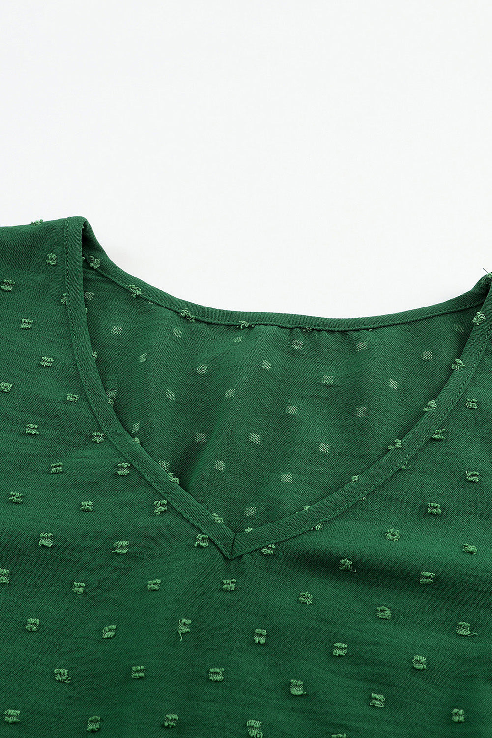 Blouse verte à pois suisses à manches doubles bouffantes