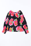 Blouse noire à manches bouffantes et imprimé floral