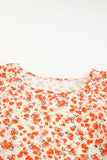 Blouse fleurie orange à manches flottantes et à plusieurs niveaux