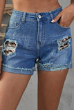 Short en jean noir à ourlet roulé et patchwork floral