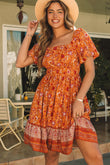 Robe fleurie fluide orange à col carré et manches bouffantes