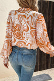 Blouse orange à surplis à manches évêque et imprimé floral tourbillonnant