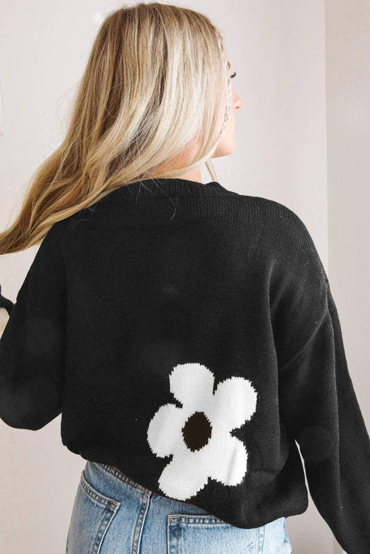 Pull en tricot noir à motif de grandes fleurs