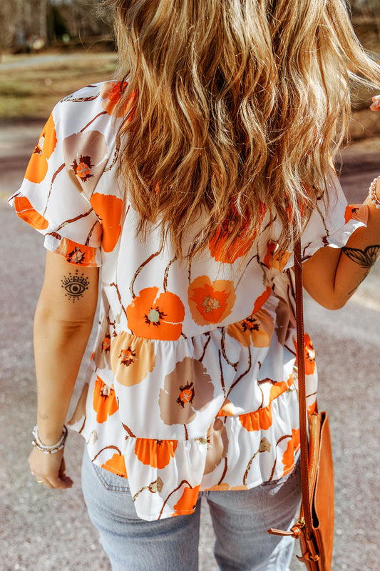 Blouse babydoll orange à imprimé floral et col volanté 