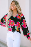 Blouse noire à manches bouffantes et imprimé floral