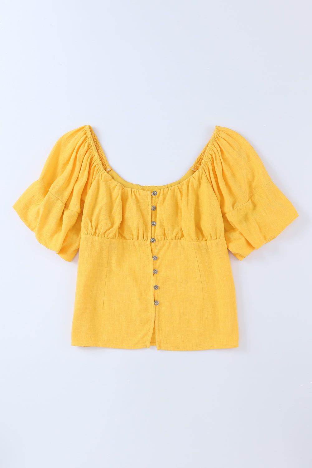 Blouse jaune froncée boutonnée à manches bouffantes