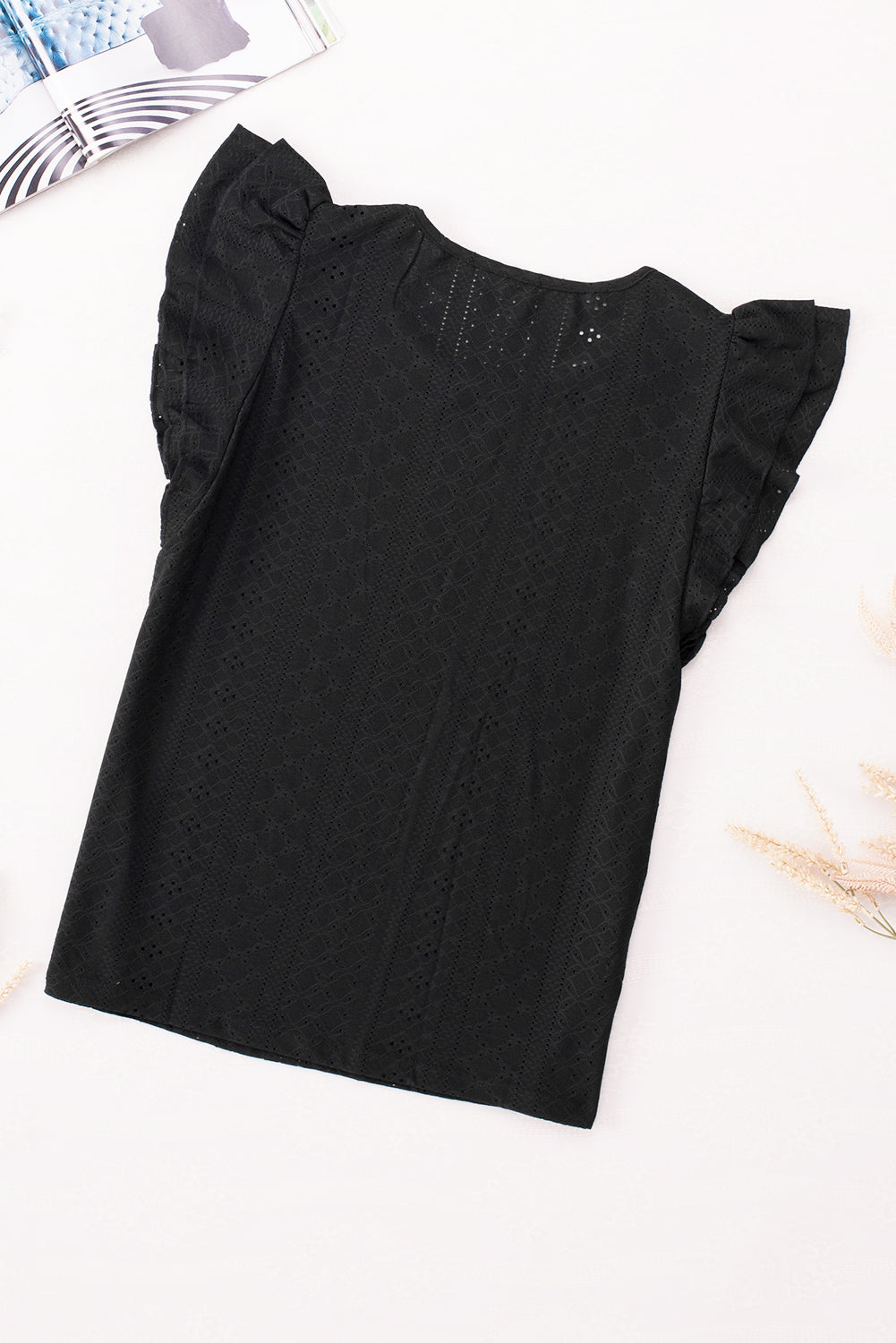 Blouse noire à manches courtes et volants texturés en losange