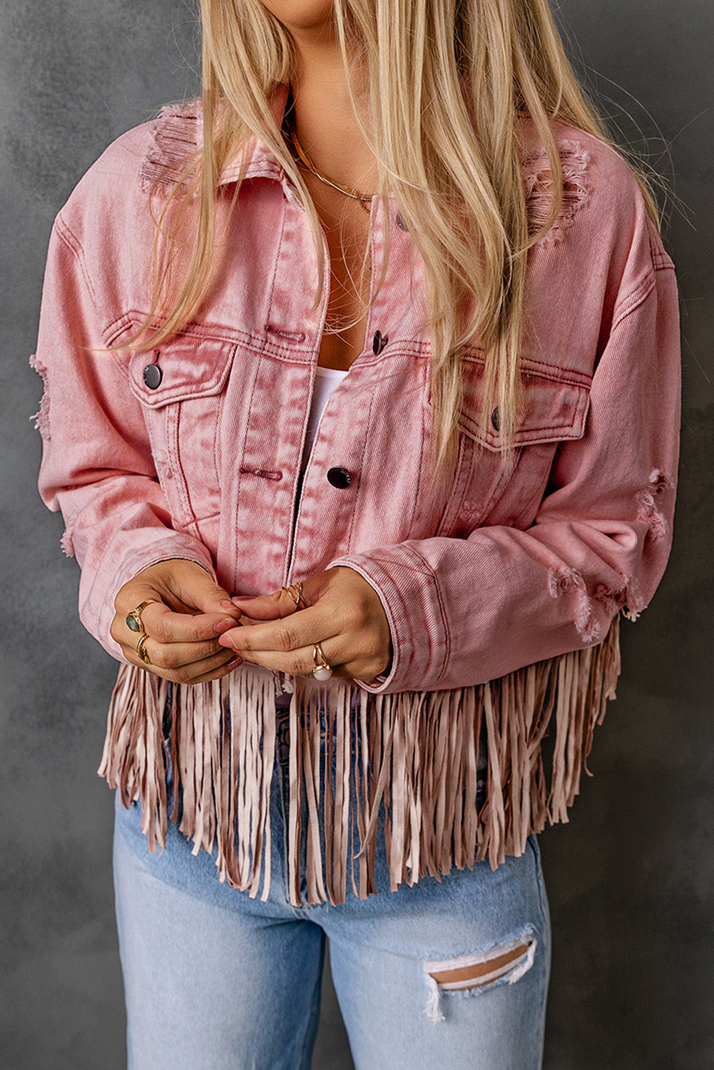 Veste en jean courte rose effet vieilli à franges