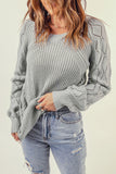 Pull en tricot gris à manches bouffantes et ajourées 