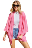 Cardigan en tricot rose à manches kimono ouvert sur le devant