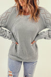 Pull en tricot gris à manches bouffantes et ajourées 