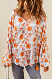 Blouse dolman orange fendue à col en V et imprimé floral 