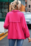 Blouse fluide rose à col en V et manches bouffantes