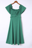 Robe midi verte smockée à épaules dénudées et nouée au dos